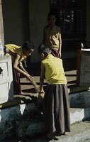 Novice monks performing daily chores 